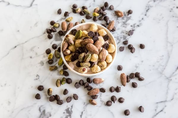 Nuts and seeds in a bowl and on table