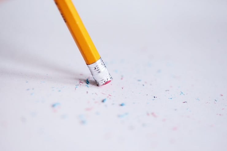Common keto mistakes symbolized by a person erasing something written on paper