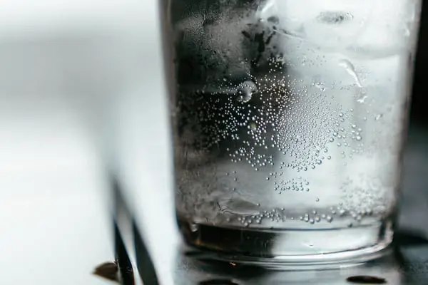 Cold glass of water with a black straw