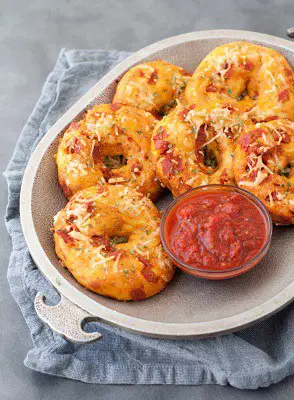 Keto pizza bagels on a plate with sauce