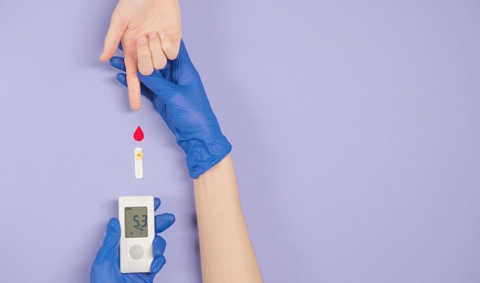 Person taking finger prick test to measure blood sugar