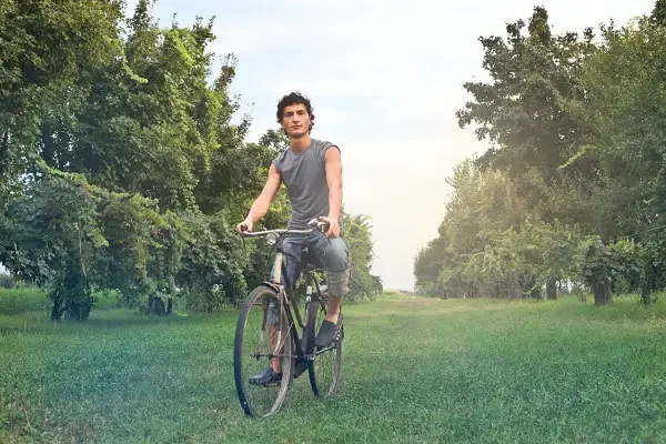 Man riding a bike in a field