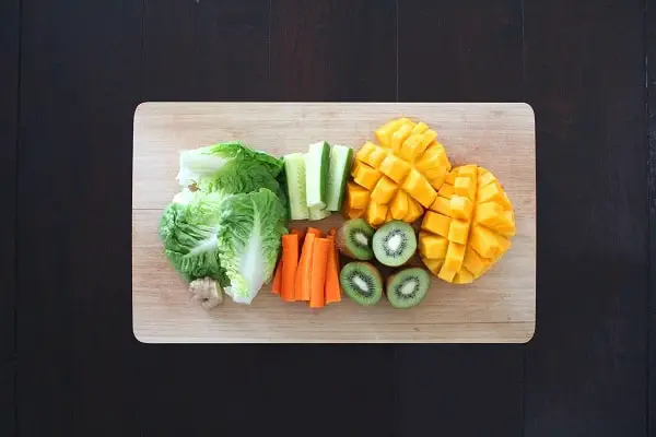 range of low-carb fruits and veggies on a chopping board