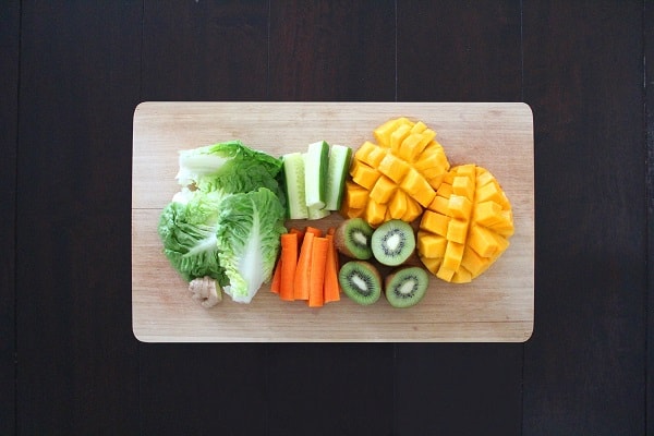 range of low-carb fruits and veggies on a chopping board