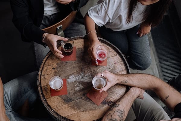 bird's eye view of 4 people having alcoholic drinks