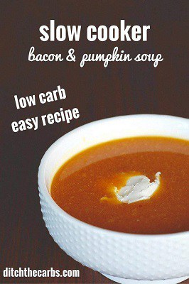 Slow cooker keto pumpkin and bacon soup in a bowl with sour cream