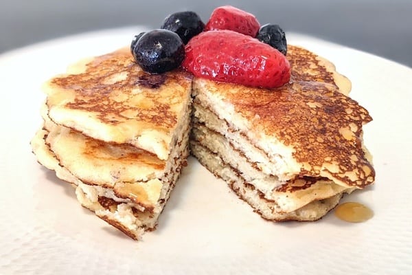 keto cottaeg cheese pancakes with berries and syrup