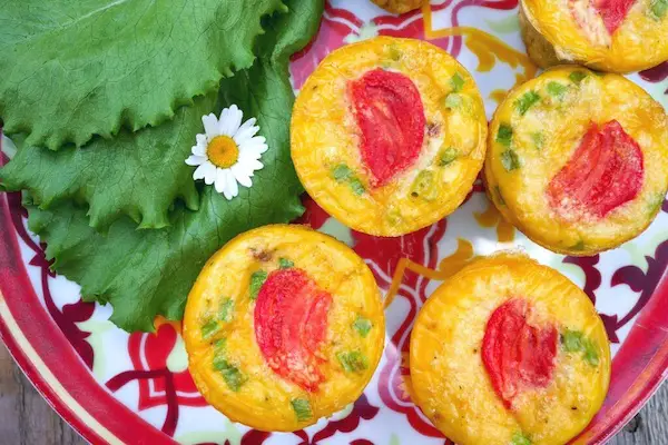 keto egg muffins with sausage on a red plate 