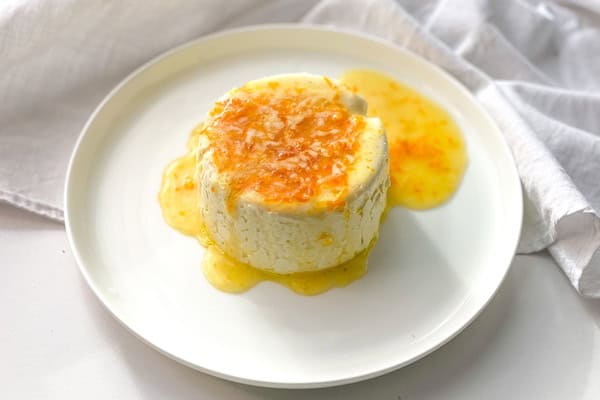 keto panna cotta on a white plate with range marmalade