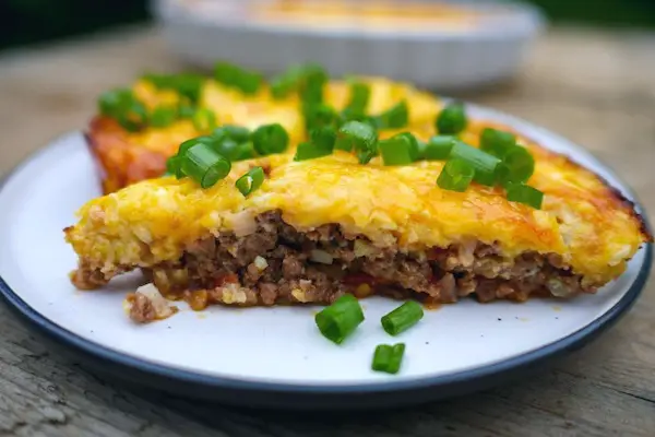 keto ricotta lasagna on a white plate with spring onions garnish