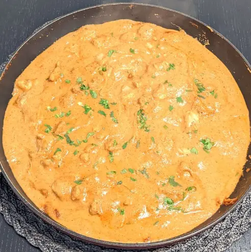 lazy keto butter chicken in a frying pan ready to be served