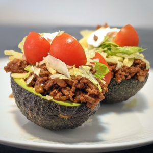 keto taco stuffed avocados on a white plate