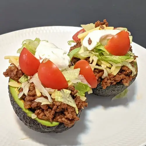 keto taco stuffed avocados on a white plate