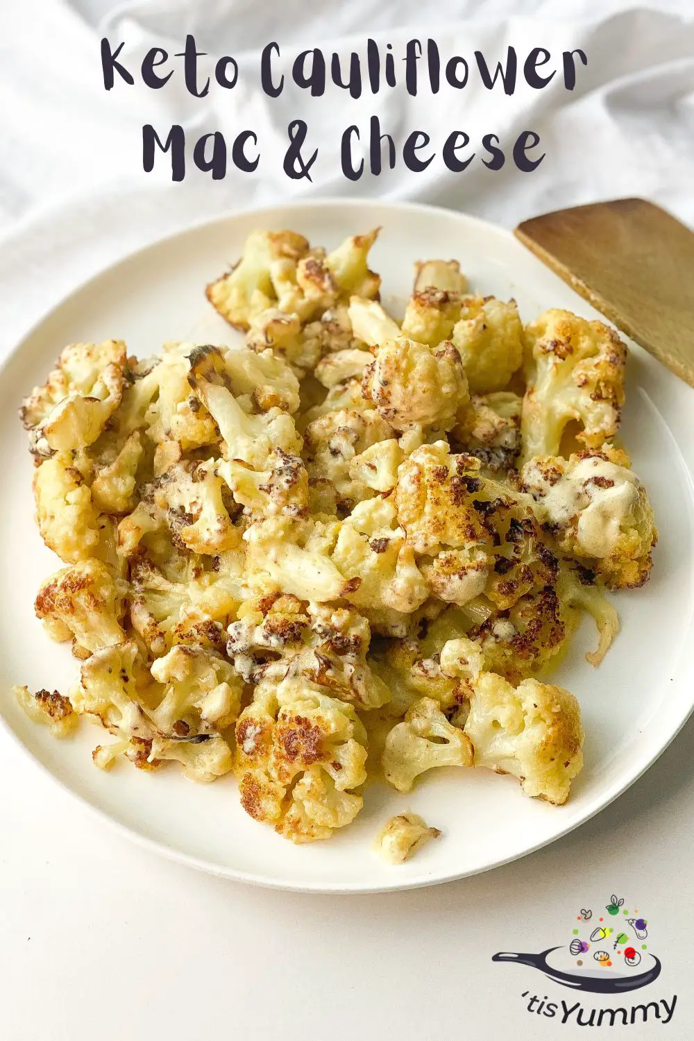 keto cauliflower mac and cheese on a plate with a wooden spoon
