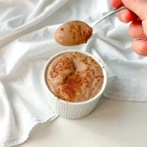 keto chocolate cottage cheese mousse being spooned out