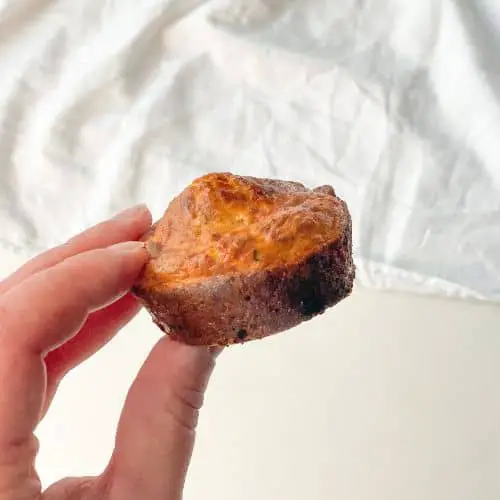 hand holding a keto cottage cheese breakfast muffin
