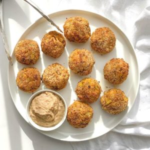 keto cottage cheese broccoli balls with tahini dip on a white plate