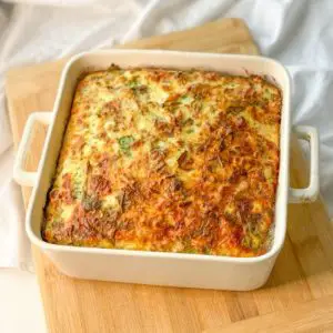keto cottage cheese egg and sausage frittata in a baking dish on cutting board