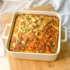 keto cottage cheese egg and sausage frittata in a baking dish on cutting board