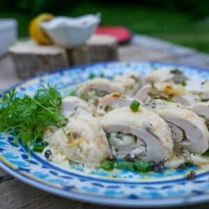 keto ricotta stuffed chicken breast on a plate with garnish