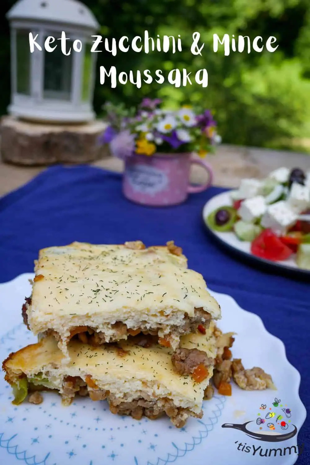 keto moussaka with zucchini and mince on a table with greek salad