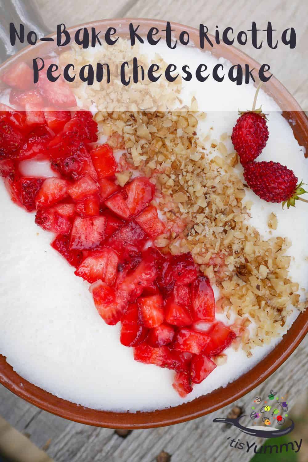 keto ricotta pecan cheesecake in a dish with strawberries and pecans on top