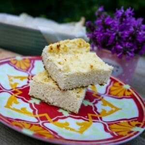 keto ricotta cake stacked two pieces high on a colorful plate