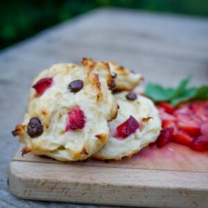 keto ricotta cookies on a chopping board with some fresh fruit slices