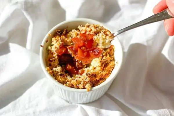 keto strawberry and rhubarb crumble in a white bowl