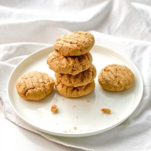 vegan peanut butter protein cookies stacked on a white plate